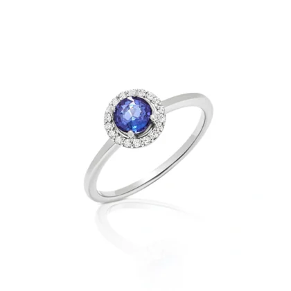 Anillo de compromiso con zafiro redondo y orla de diamantes oro blanco corsia