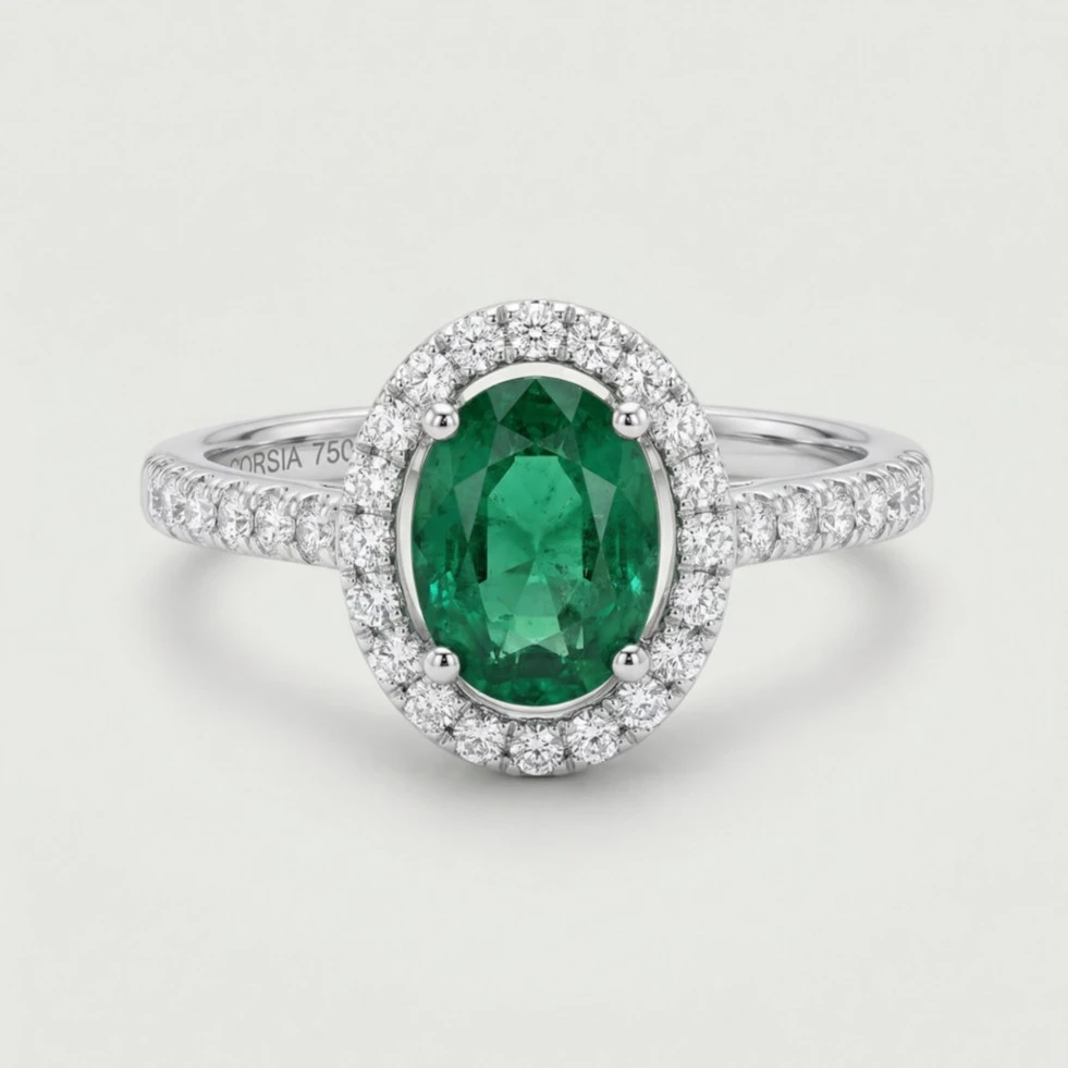 Anillo con esmeralda oval y brazo y orla de diamantes corsia